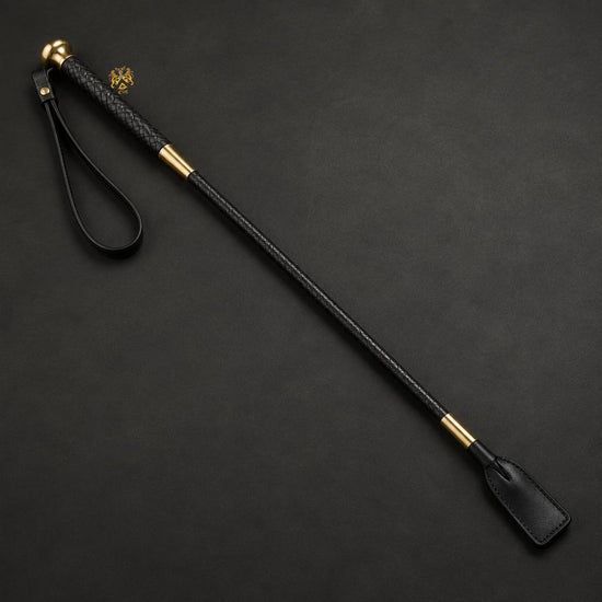 Braided black leather horse-riding whip with brass fittings and official Lion’s Crest handle stamp