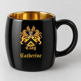 Black oval mug with gold interior, the gold lion crest, and the name Catherine in gold Old English script